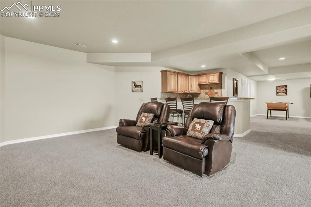 14525 Sterling Road Colorado Springs, CO 80921 - Photo 36 of 46 a living room with furniture and a view of kitchen