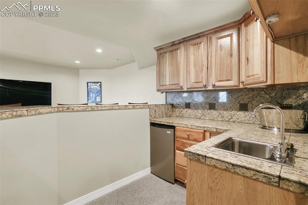 14525 Sterling Road Colorado Springs, CO 80921 - Photo 37 of 46 a kitchen with granite countertop a sink and a stove top oven