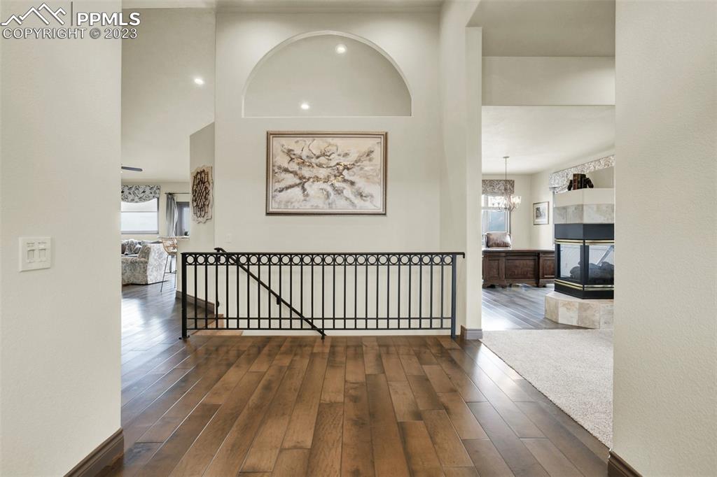 14525 Sterling Road Colorado Springs, CO 80921 - Photo 8 of 46 a view of a hallway with wooden floor and furniture