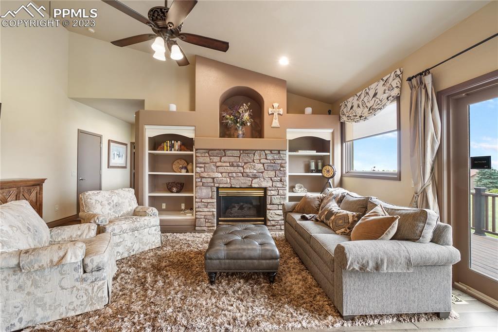 14525 Sterling Road Colorado Springs, CO 80921 - Photo 9 of 46 a living room with furniture and a fireplace