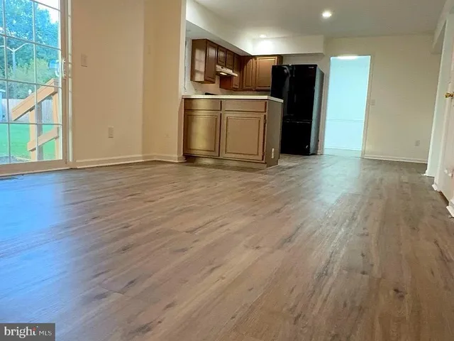 a view of kitchen with wooden floor and electronic appliances