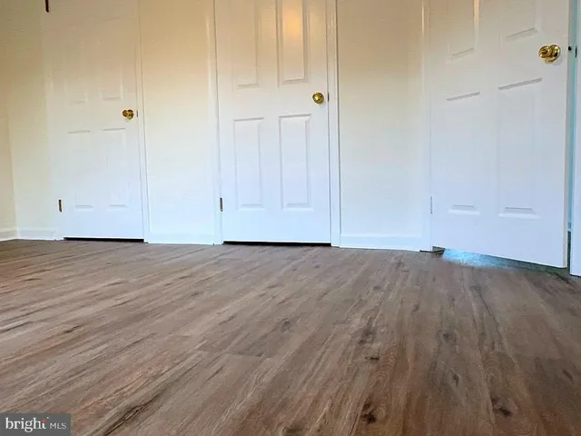 a view of room with window and wooden floor