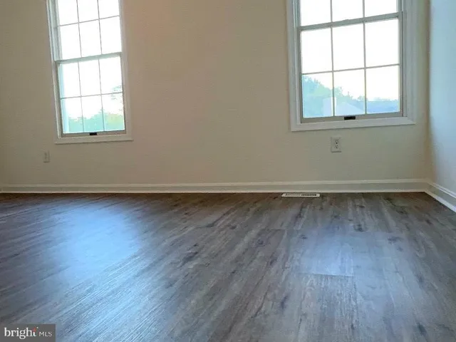 a view of a hallway view with wooden floor and staircase