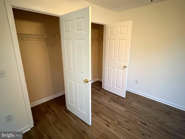 an empty room with wooden floor and a door