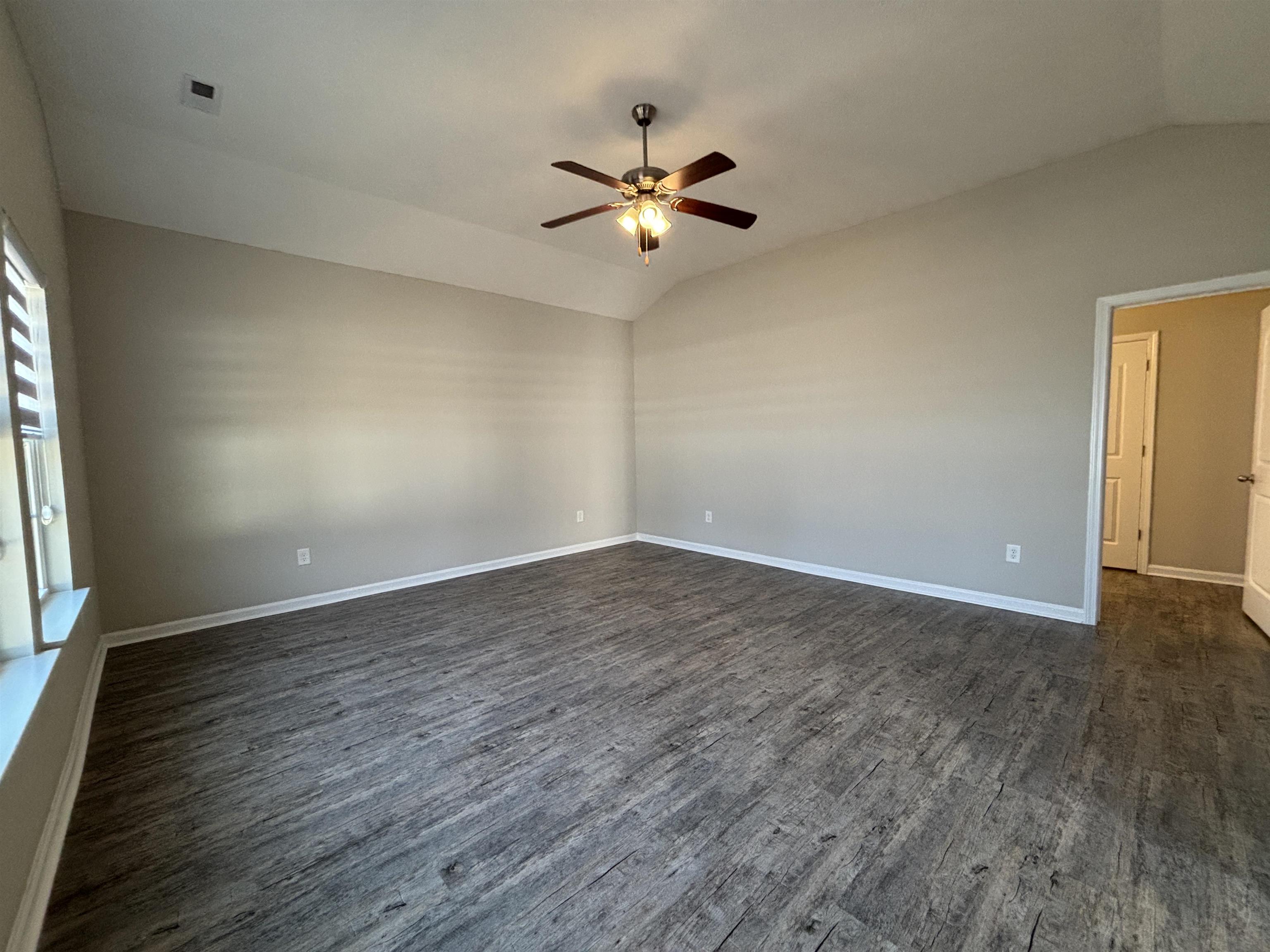 227 Leste Road Myrtle Beach, SC 29588 - Photo 10 of 33 Unfurnished room with vaulted ceiling, dark wood-style floors, and ceiling fan
