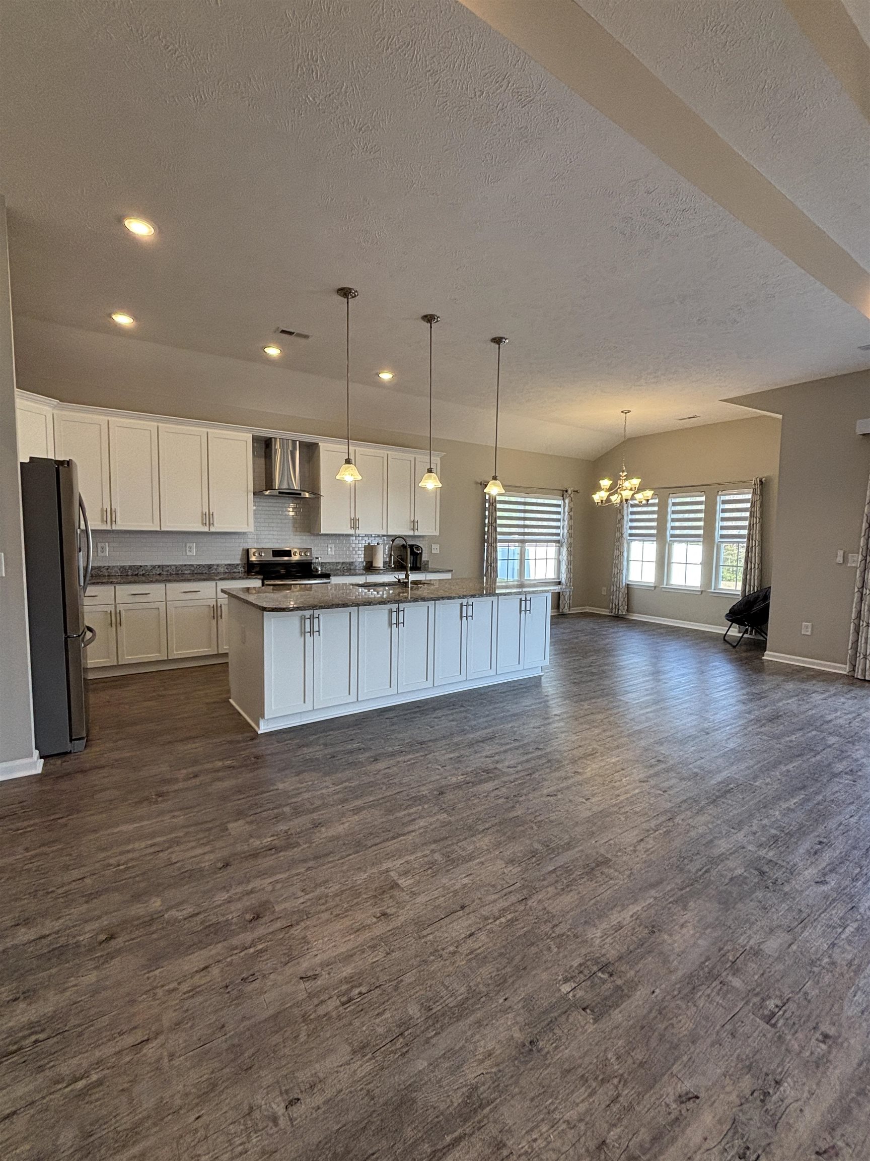 227 Leste Road Myrtle Beach, SC 29588 - Photo 33 of 33 Kitchen with open floor plan, pendant lighting, a chandelier, white cabinets, and a textured ceiling