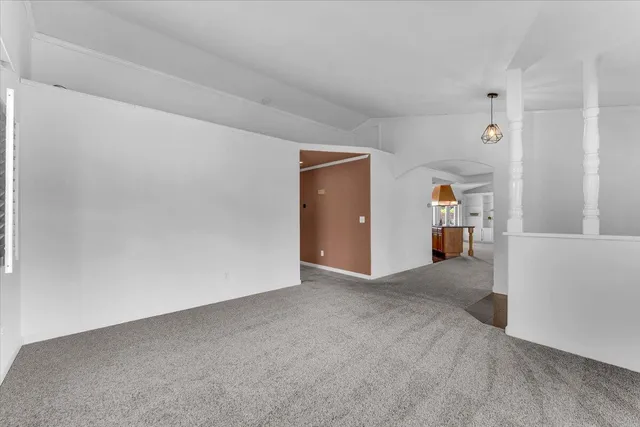 a view of a pathway with a wrought fence