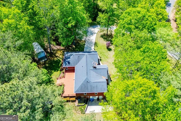 an aerial view of a house with a yard