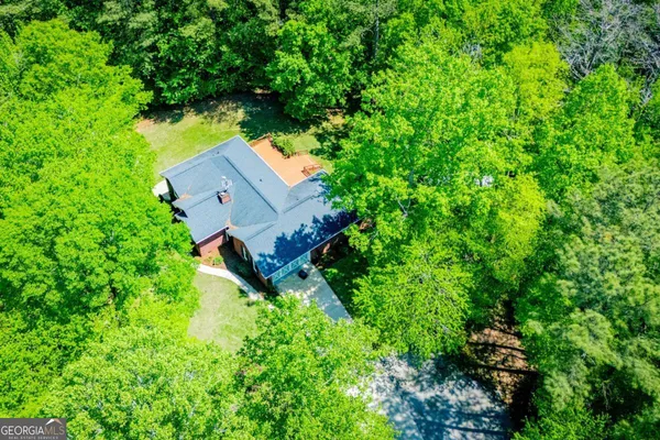 an aerial view of a house with a yard