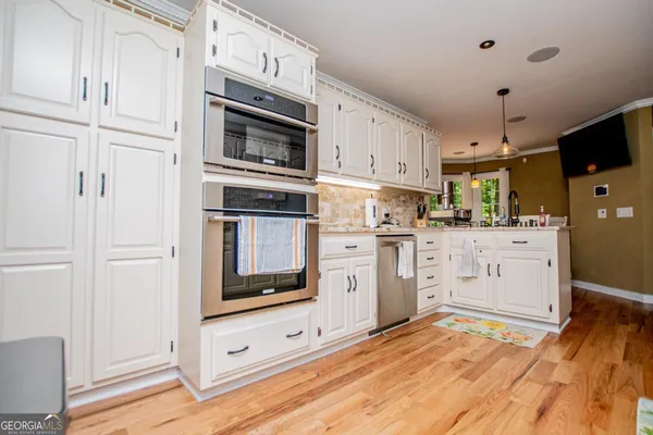 a kitchen with stainless steel appliances granite countertop a sink and cabinets