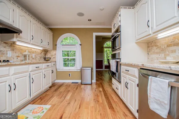 a view of a dining room with furniture and wooden floor