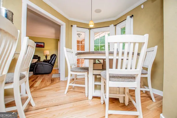 a dining room with furniture and a flat screen tv