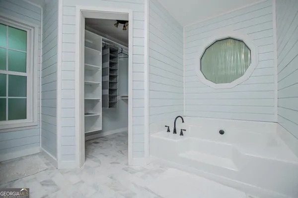 a bathroom with a bathtub and a shower