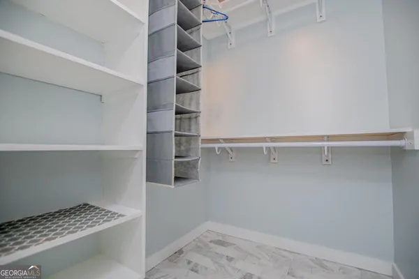 a bathroom with a granite countertop sink a mirror a vanity and a shower