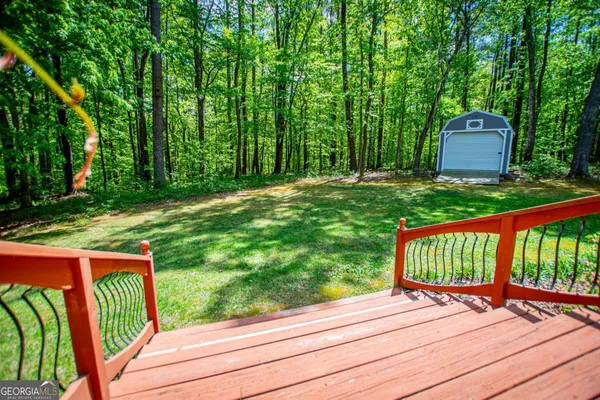 a view of a two chairs and table in the backyard