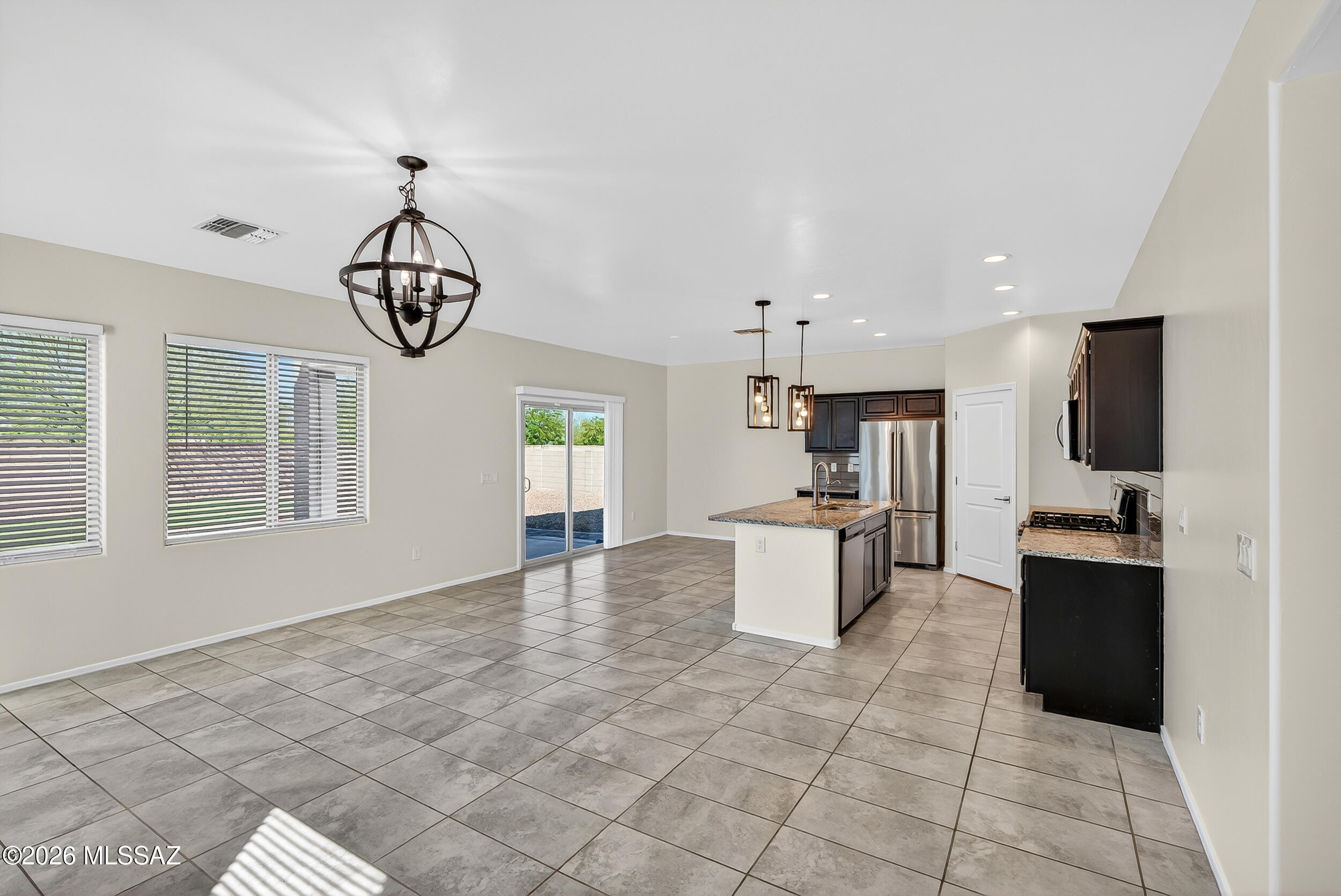 7556 South Circulo Rio Blanco Tucson, AZ 85756 - Photo 7 of 50 Expansive open-concept great room, dining area and kitchen featuring a large central island! You will find no carpeting downstairs!