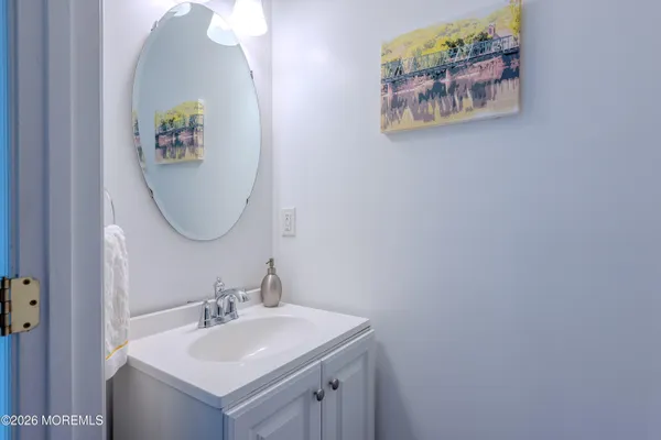 a bathroom with a sink mirror and vanity