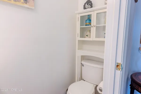a white toilet sitting next to a shower