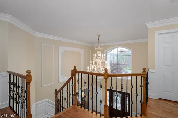 a spacious bedroom with a bed and a chandelier