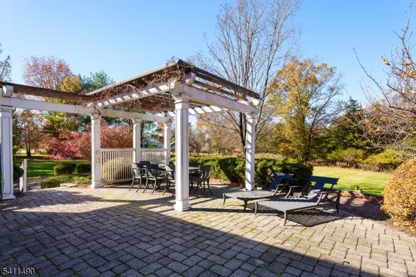 a view of a patio with a table and chairs under an umbrella