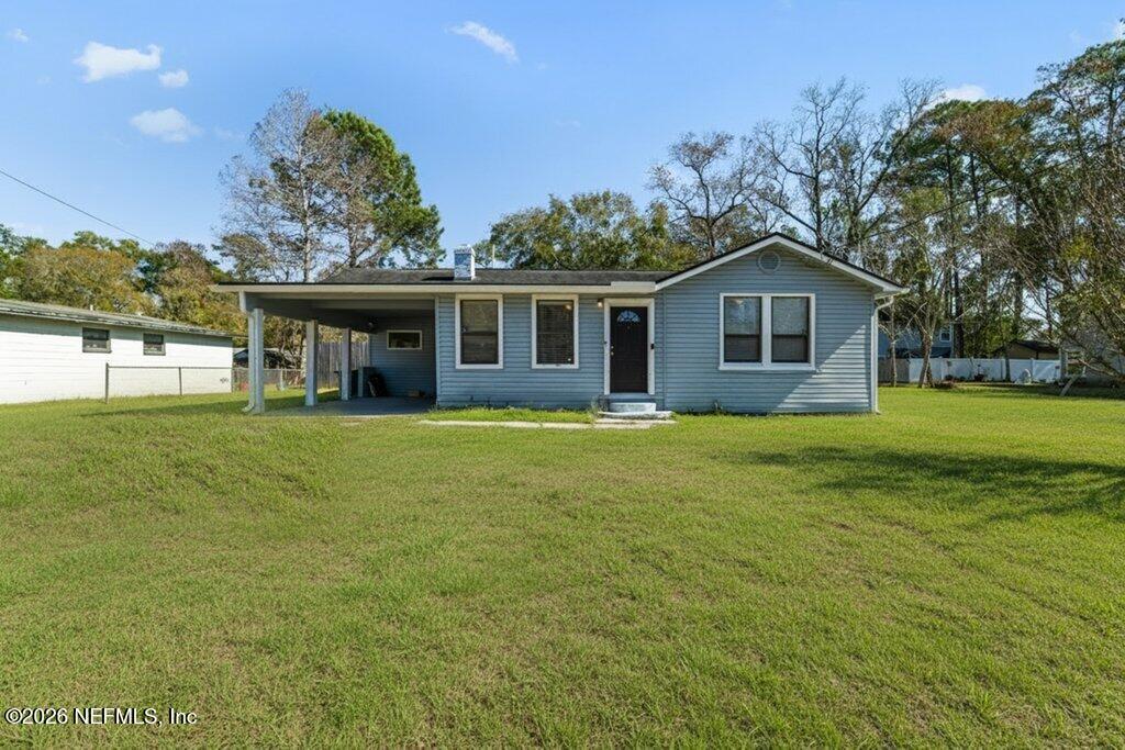 a front view of house with yard and green space