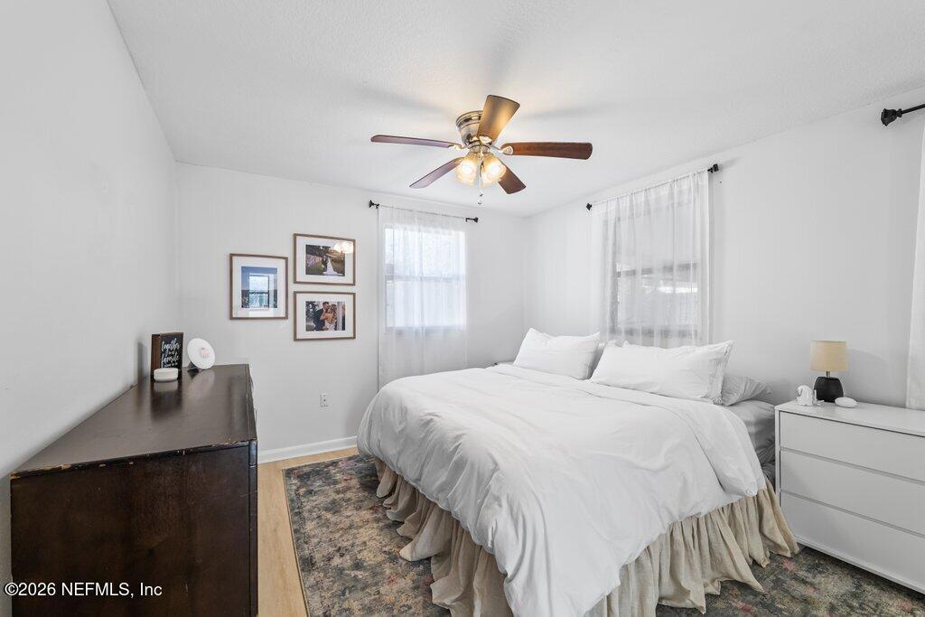 4145 Springwood Road Jacksonville, FL 32207 - Photo 12 of 33 a bedroom with a bed and a chandelier