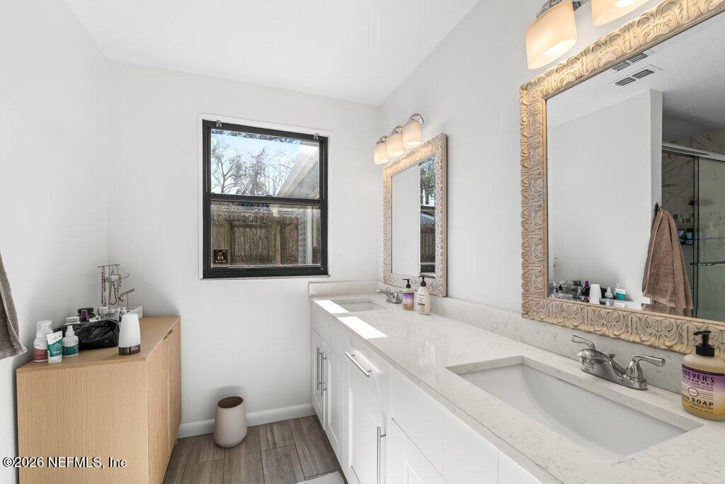 4145 Springwood Road Jacksonville, FL 32207 - Photo 14 of 33 a bathroom with a sink and a mirror