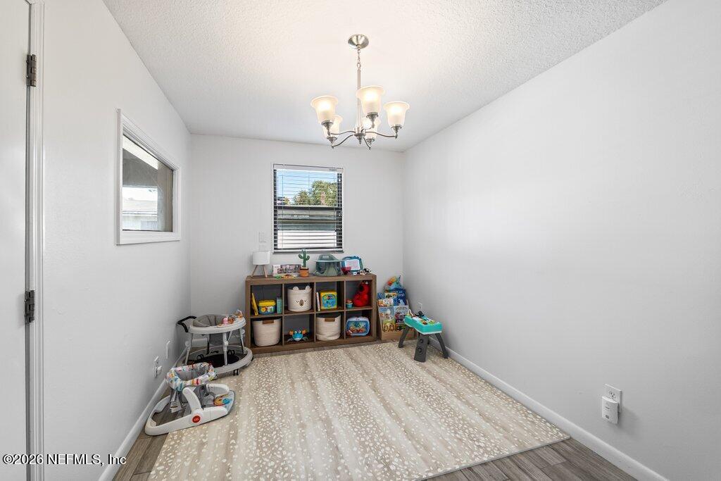 4145 Springwood Road Jacksonville, FL 32207 - Photo 18 of 33 a view of a workspace with furniture and chandelier