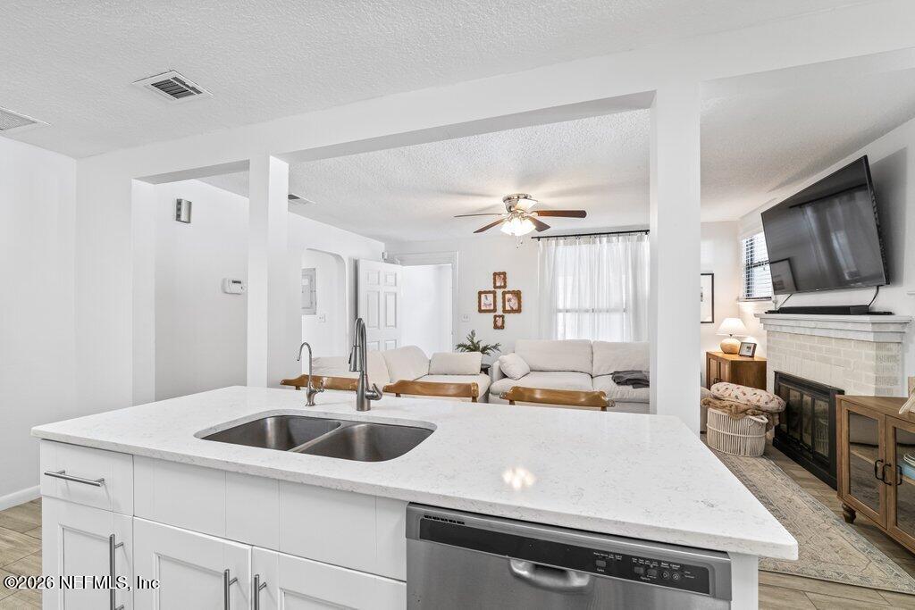 4145 Springwood Road Jacksonville, FL 32207 - Photo 4 of 33 a kitchen with a sink dishwasher a stove and a refrigerator with wooden floor