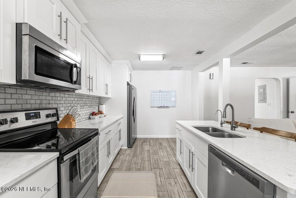 4145 Springwood Road Jacksonville, FL 32207 - Photo 5 of 33 a kitchen with a sink stove and microwave