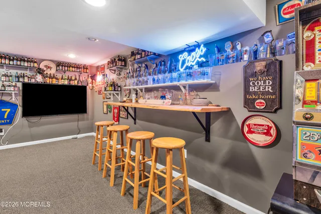 a view of a play room with furniture and a flat screen tv