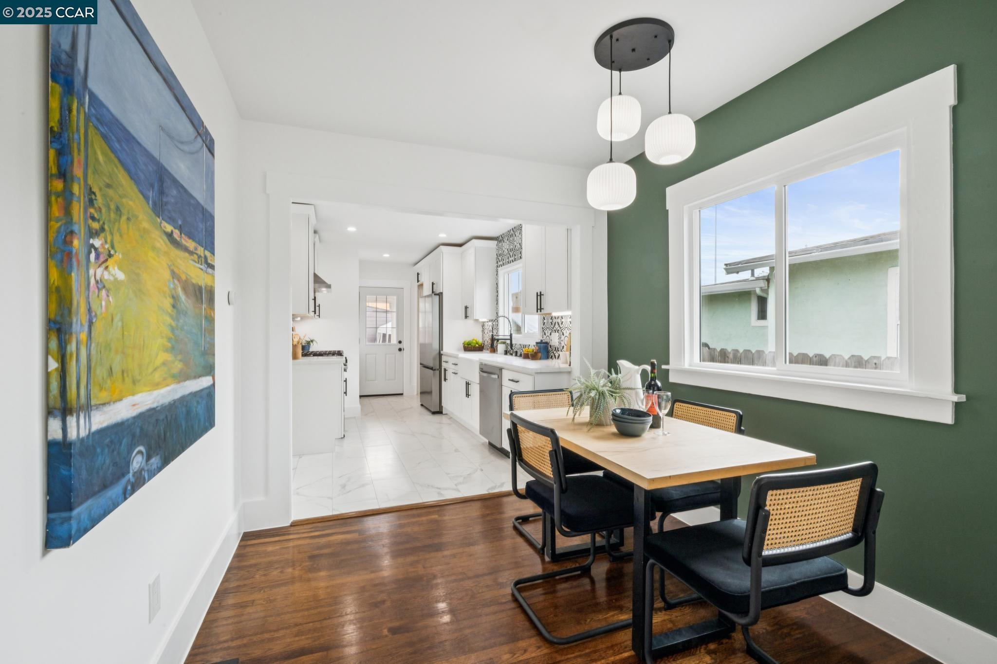 1128 60th Avenue Oakland, CA 94621 - Photo 3 of 7 a view of a dining room with furniture and wooden floor