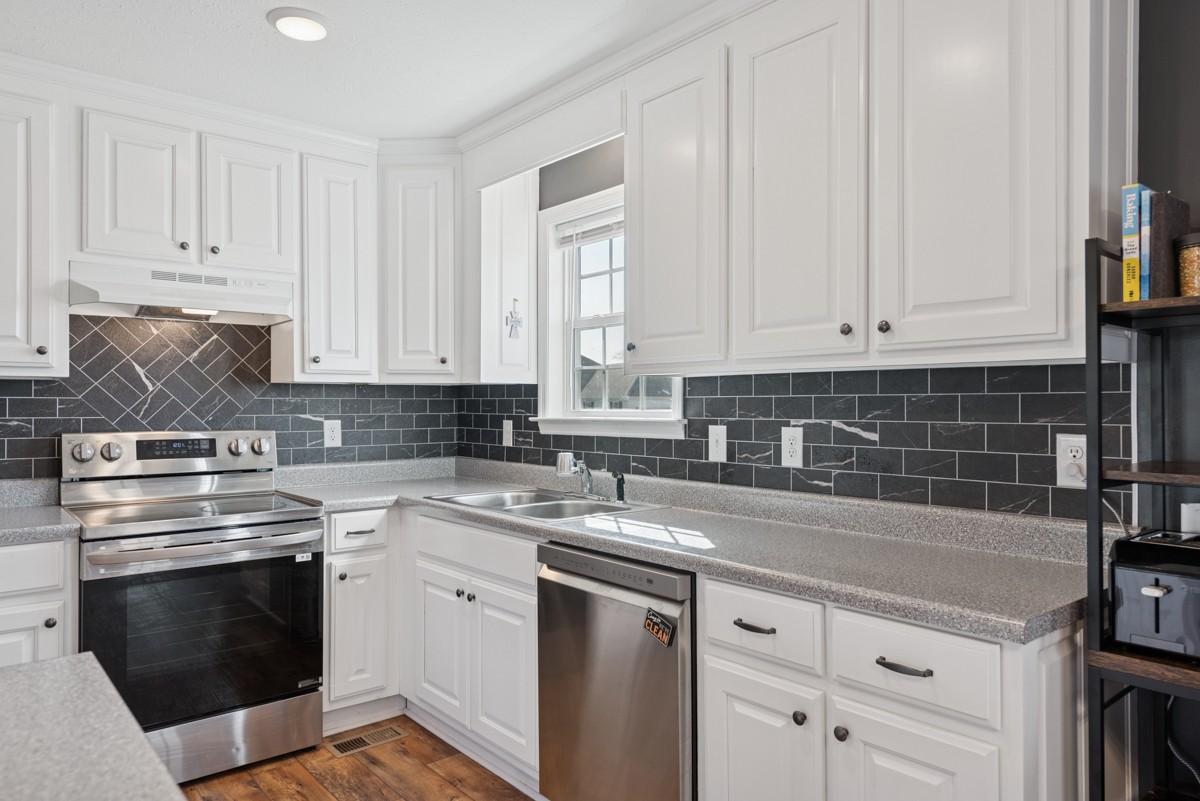 4915 Little Dry Creek Road Pulaski, TN 38478 - Photo 16 of 45 a kitchen with appliances a sink and cabinets