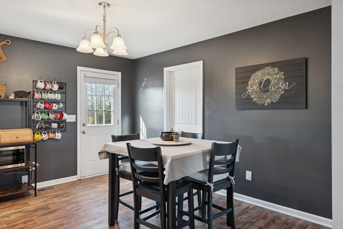 4915 Little Dry Creek Road Pulaski, TN 38478 - Photo 17 of 45 a view of a dining room with furniture wooden floor and a chandelier