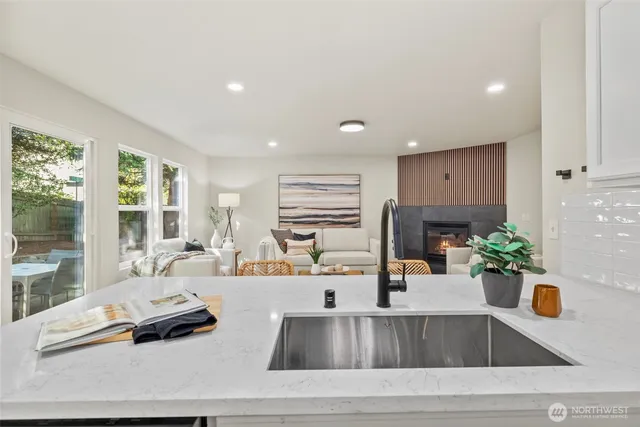 a kitchen with a sink and living room