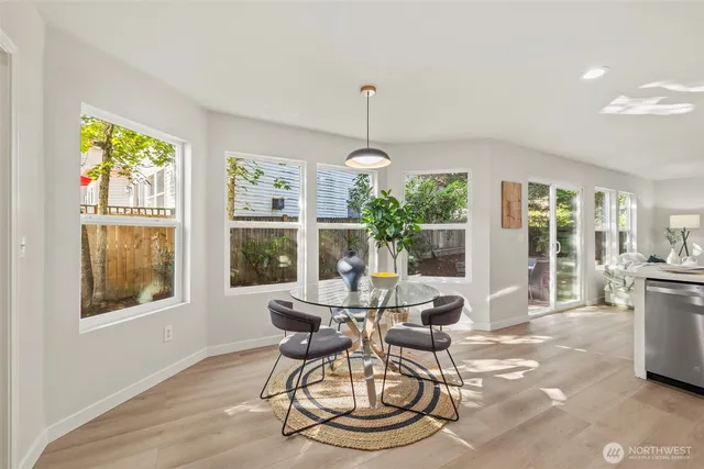 a dining room with furniture a chandelier and wooden floor