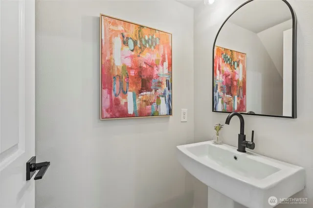 a bathroom with double vanity sinks and a shower