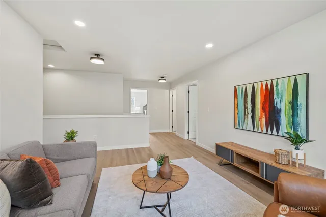 a living room with furniture and a potted plant