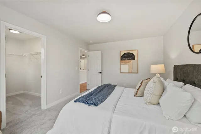 a bedroom with a bed and a mirror