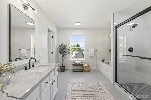 a bathroom with a granite countertop sink a mirror and a shower