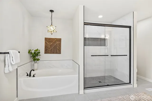 a bathroom with a bathtub and a shower