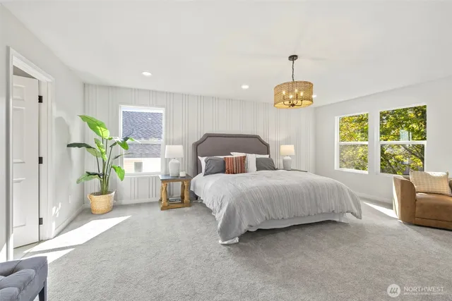 a bedroom with a bed and a chandelier