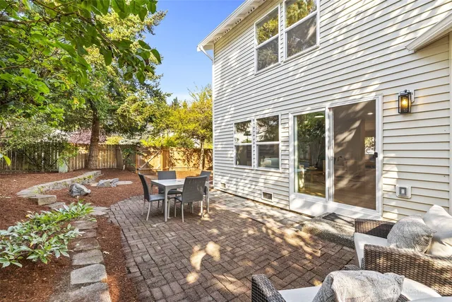 a view of a patio with table and chairs and potted plants