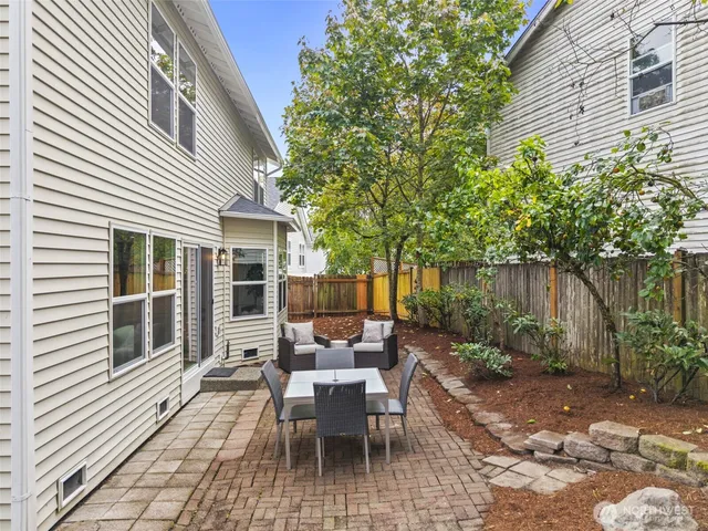 a view of a patio with table and chairs and potted plants