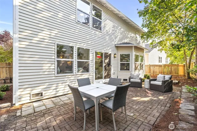 a backyard of a house with outdoor seating