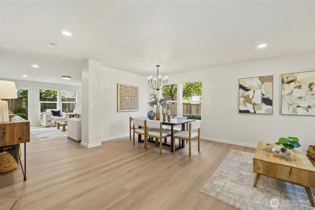 a living room with furniture wooden floor and dining table