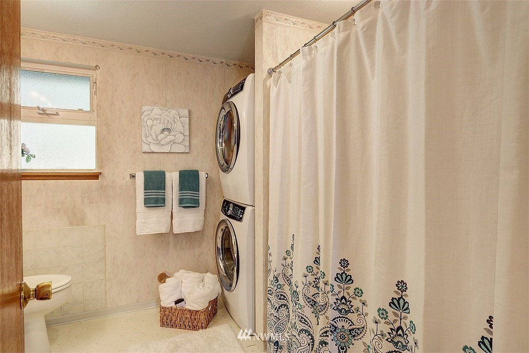 24217 4th Place West Bothell, WA 98021 - Photo 11 of 19 a bathroom with a shower curtain and a window
