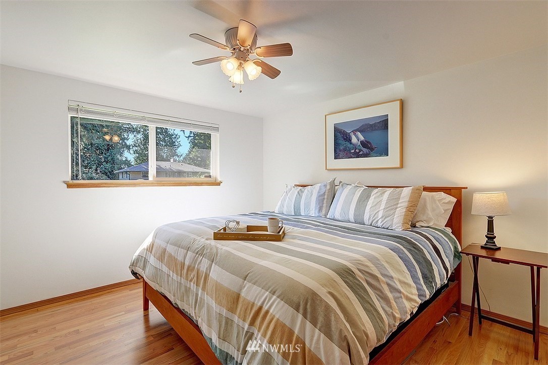 24217 4th Place West Bothell, WA 98021 - Photo 14 of 19 a bedroom with a bed and a chandelier
