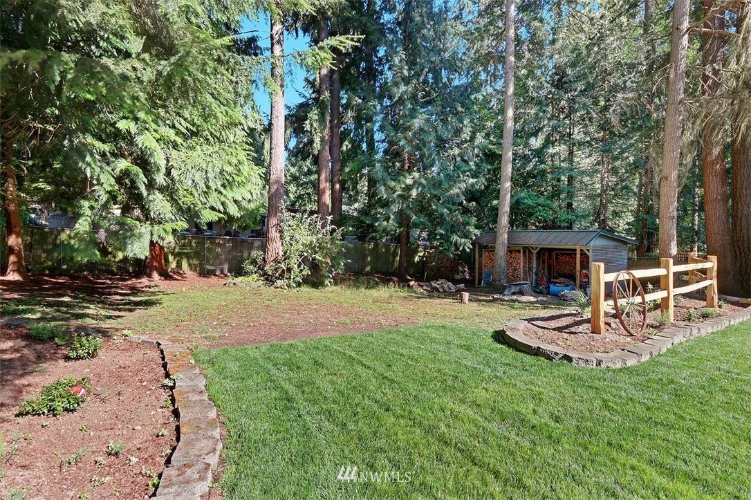 24217 4th Place West Bothell, WA 98021 - Photo 17 of 19 a view of a backyard with table and chairs and wooden fence
