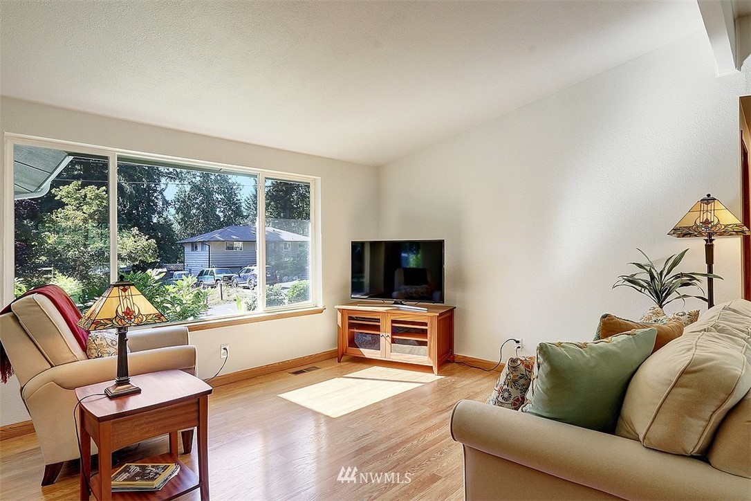 24217 4th Place West Bothell, WA 98021 - Photo 8 of 19 a living room with furniture a flat screen tv and a large window
